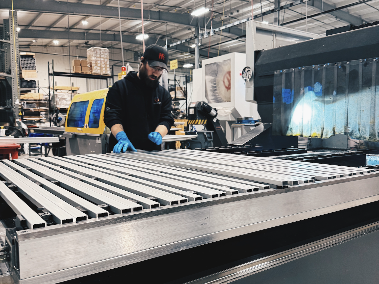TentCraft metal fabrication employee works on tent legs at the production facility in Traverse City, Michigan