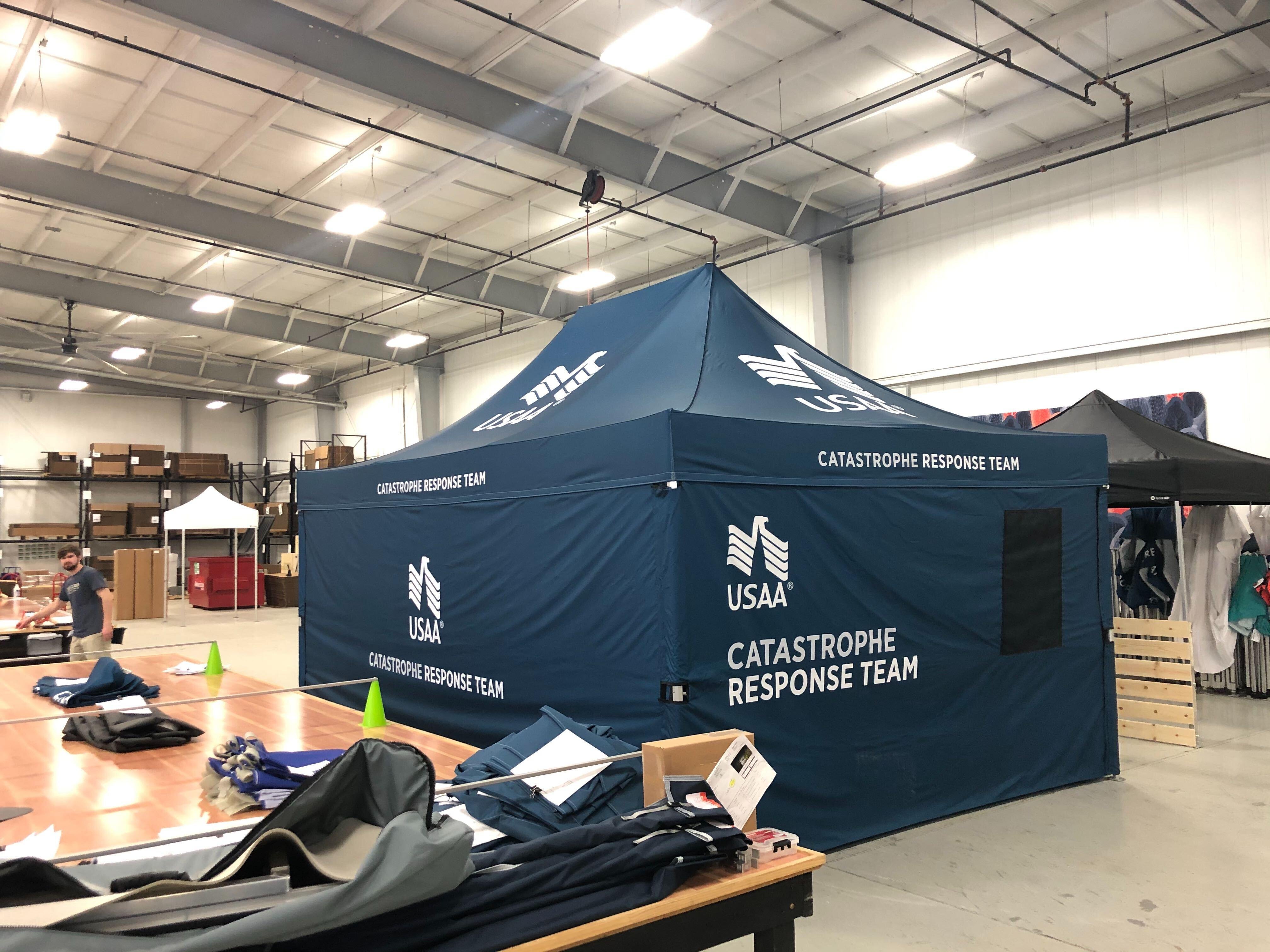 Navy blue pop-up medical tent shelter with USAA custom logo printing and words Catastrophe Response Team