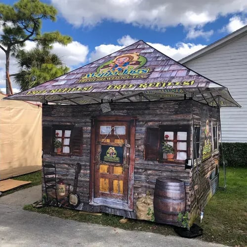 A pagoda style 10x10 pop-up tent with full walls used for iced tea concessions at fairs and festivals.