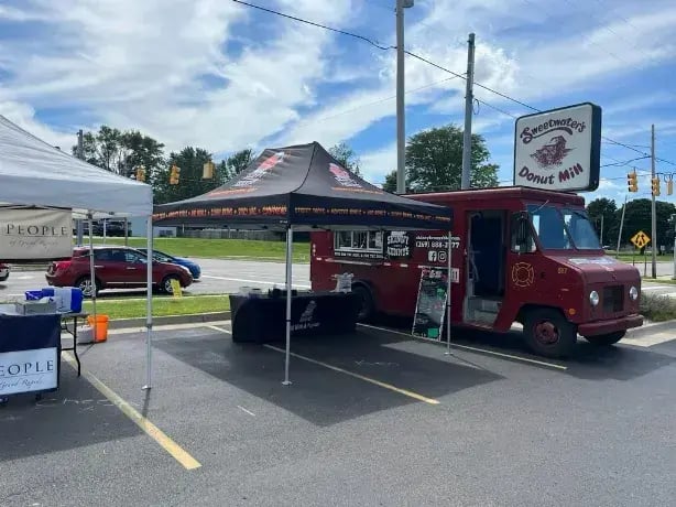 A 10x15 medium-duty pop-up tent for Skinny Kenny BBQ.