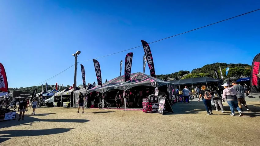 20x30 X-Series Frame Tent with Feather Flags for Muc-Off