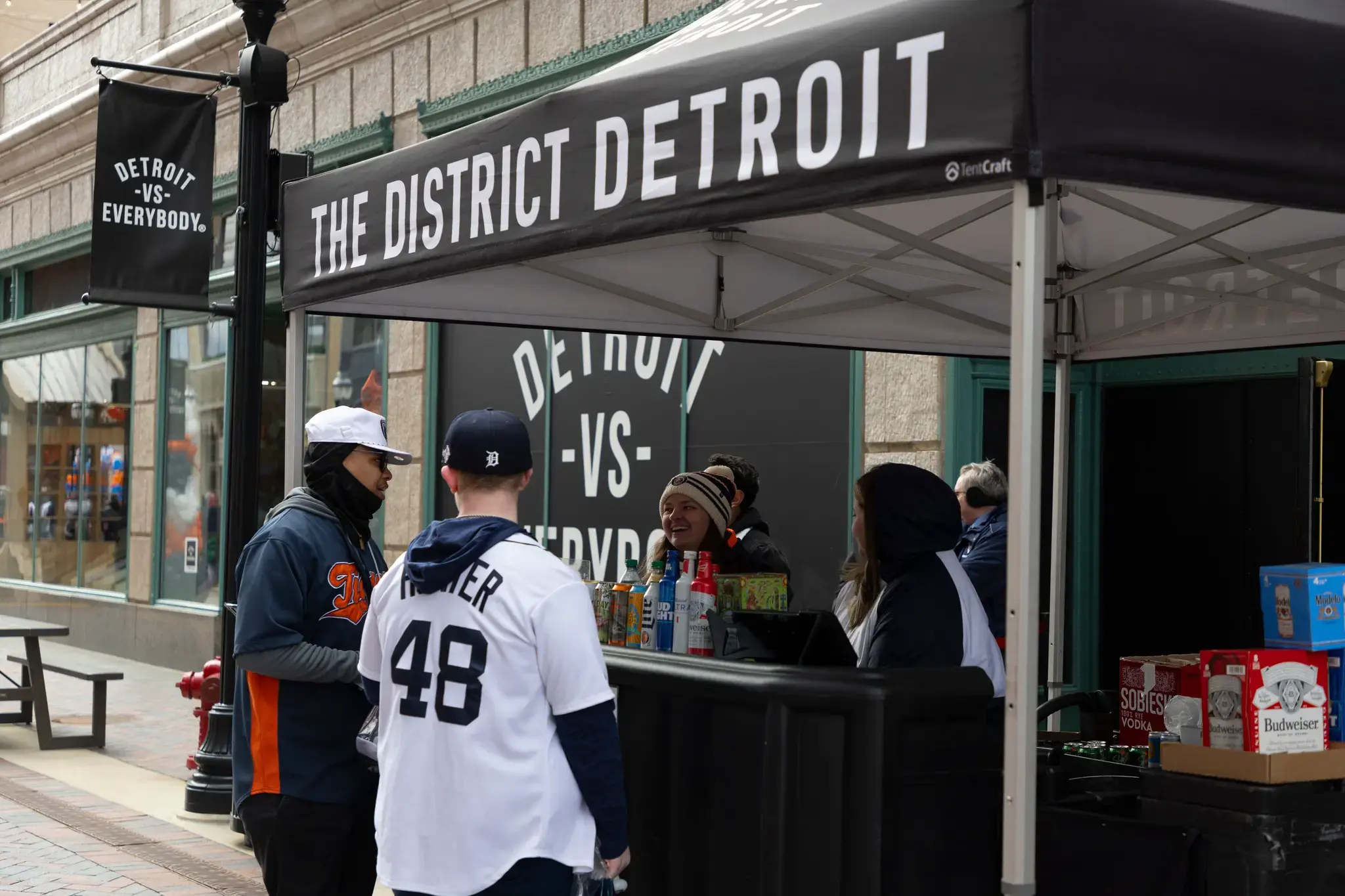 Detroit Tigers fans grab a beer from a District Detroit pop-up tent before a game