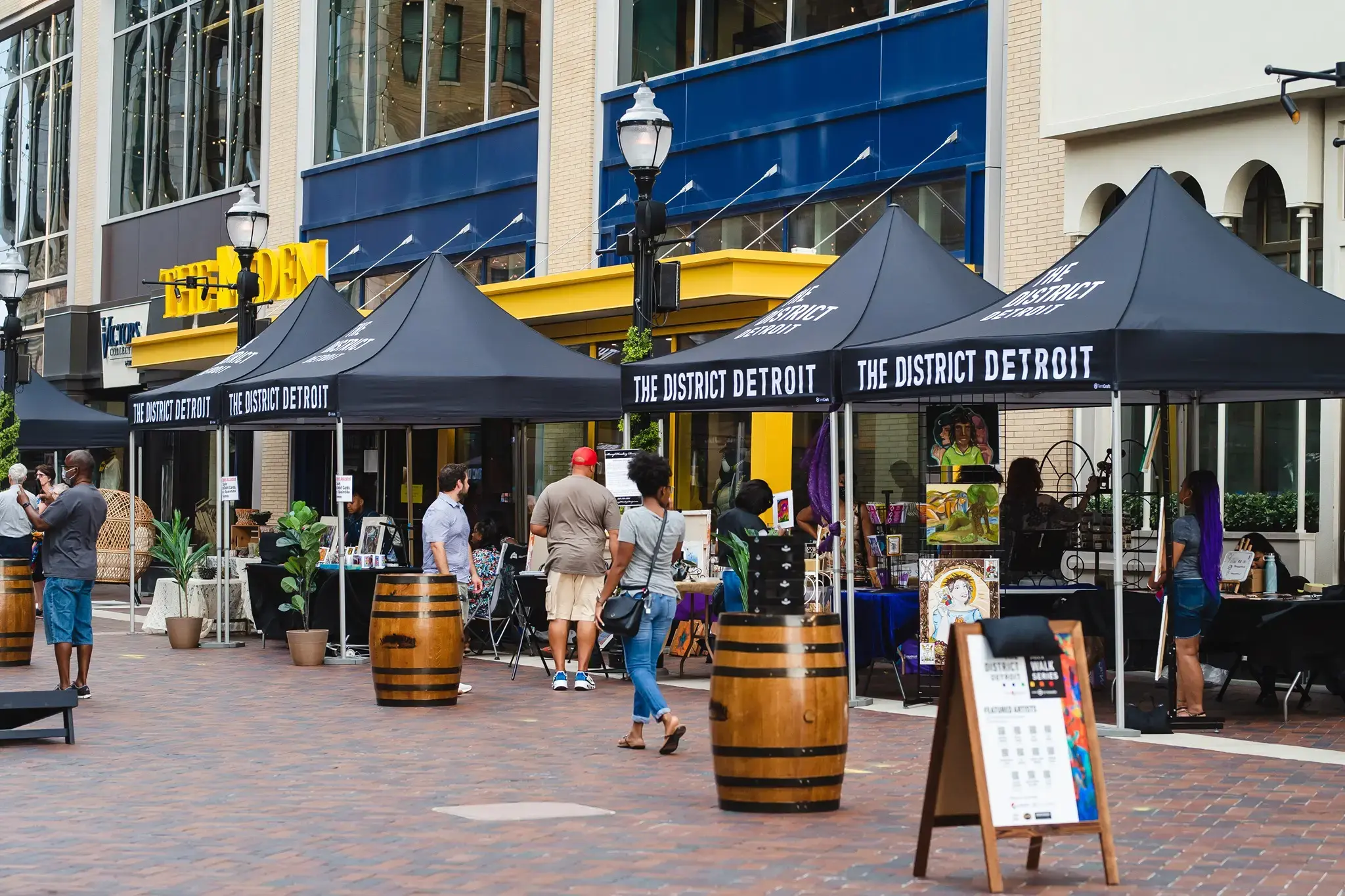 Shoppers attend an art fair in the District Detroit