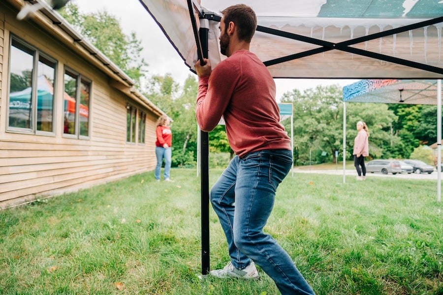 A man sets up a heavy-duty pop-up tent