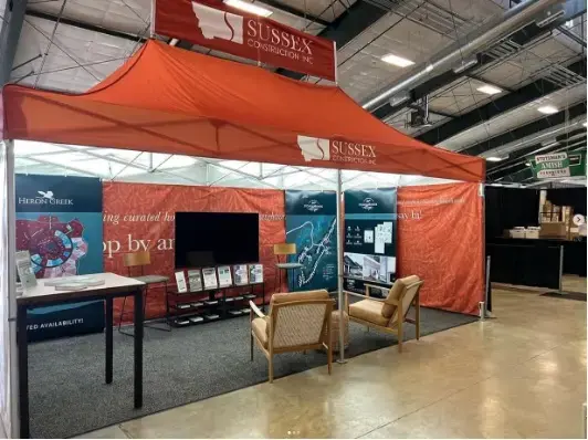 Orange 10x20 MONARCHTENT set up at an indoor event. 