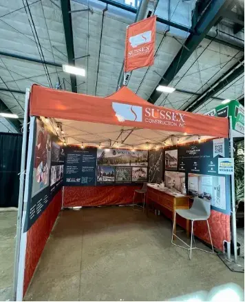 Orange 10x10 MONARCHTENT set up at an indoor event.