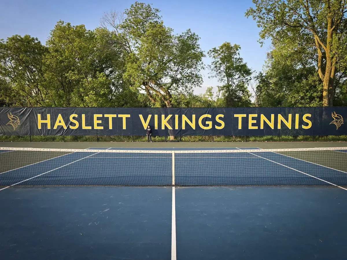 Large fence scrim for tennis court signage