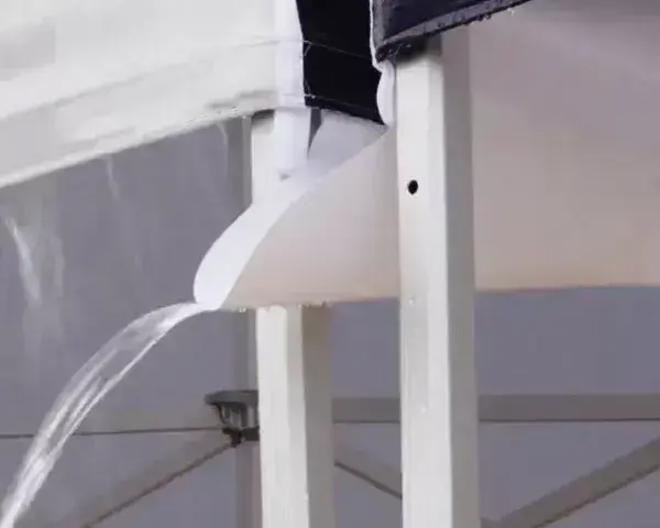 A rain gutter installed between two pop-up tents.